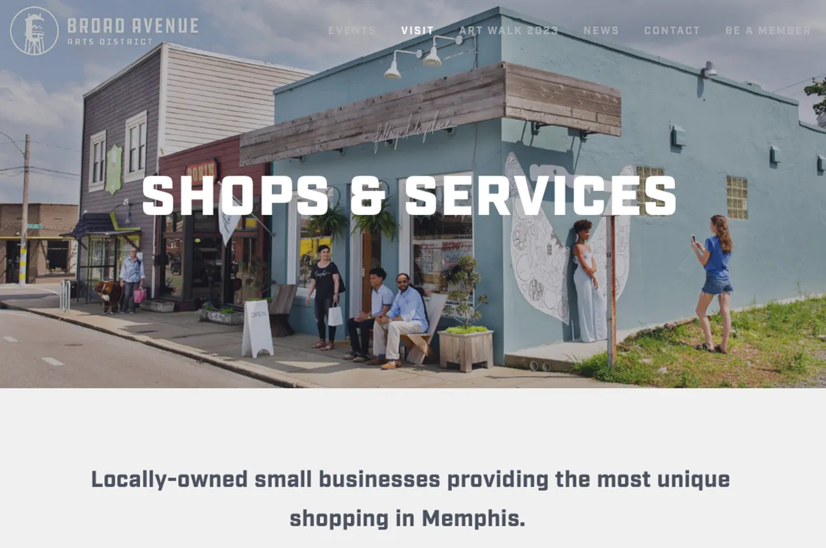 The image reveals a lively Memphis street lined with colorful storefronts and people interacting. Art adorns the walls, and the scene buzzes with the energy of community and creativity. The presence of locals and visitors exploring boutique shops and appreciating public art captures the essence of neighborhood discovery.